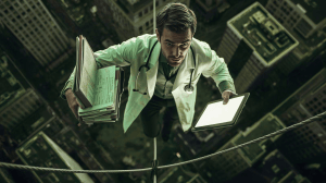 A doctor walking a tightrope holding files in one hand and a computer tablet in the other. 