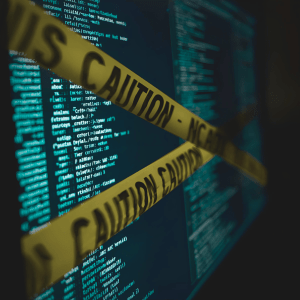 A computer screen with personal data on it and caution police tape across the monitor. 